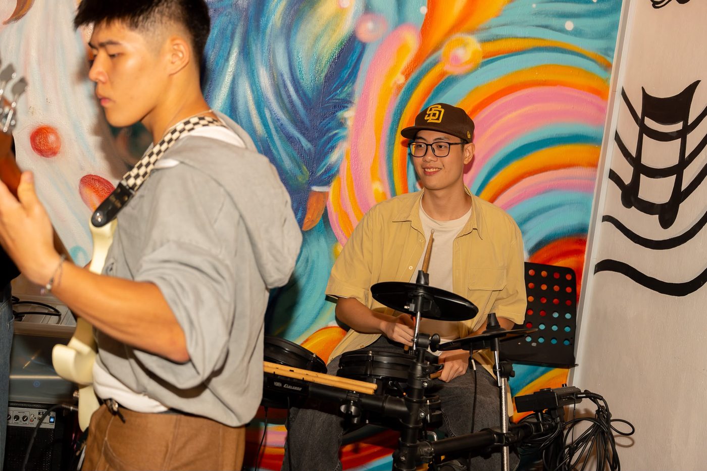 Jorell teaching and playing an electronic drum kit