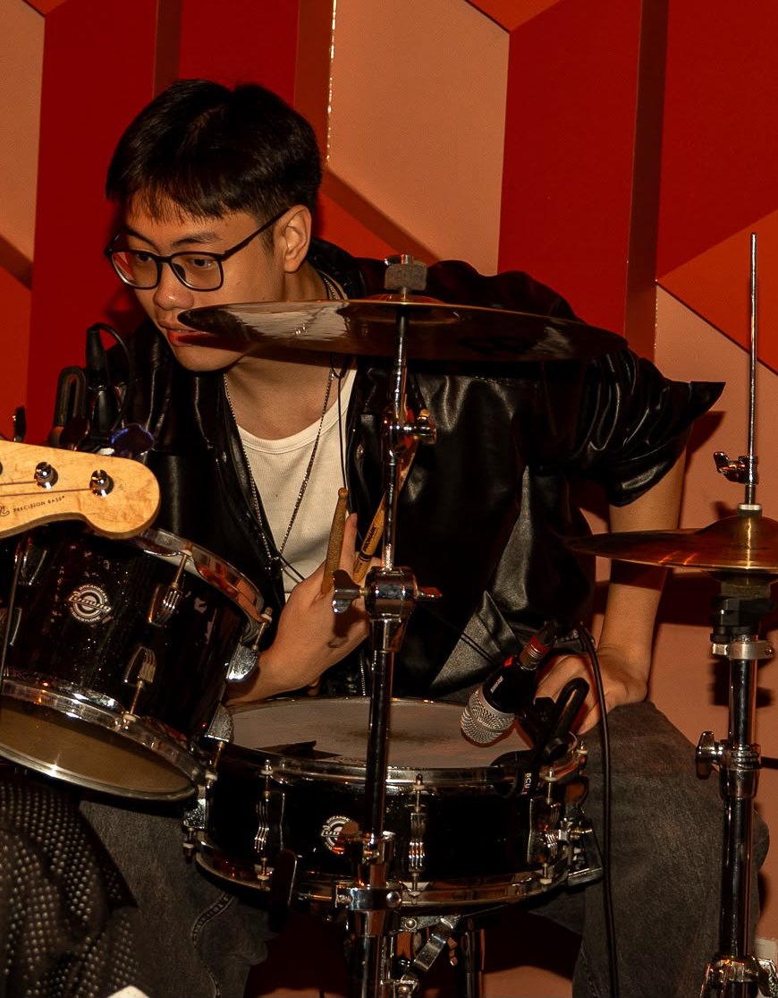 Jorell playing drums on stage